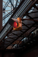 Fototapeta na wymiar Traffic light on old train bridge (red light)