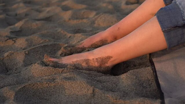 feet in the sand on sunny day