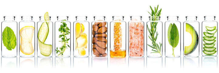 Homemade skin care with natural ingredients avocado ,aloe vera ,cucumber ,himalayan salt  ,honeycomb ,almonds, ginger slice and rosemary  in glass bottles isolate on white background.