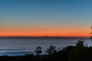 Fototapeta na wymiar Scenic Newport Coast vista at sunset with the Santa Catalina island in the backgrounds, Southern California