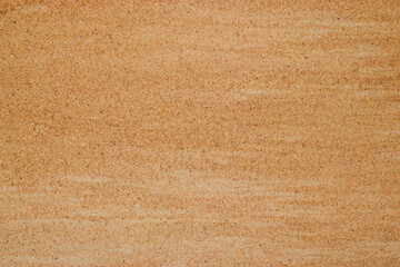 Sand background. Natural light beige or red sandy beach texture.