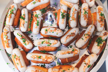 Catering table, beautifully decorated banquet table with variety of different food snacks, sandwiches, croissants and appetizers on party event or celebration, delicatessen setting, coffee break