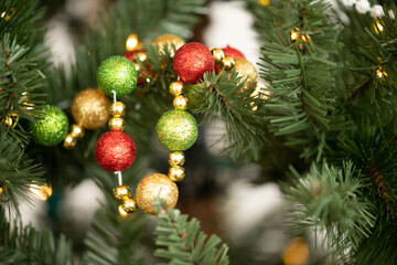 Red Green Gold Garland in a Christmas Tree