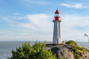 Fototapeta na wymiar Lighthouse on the rock in the ocean