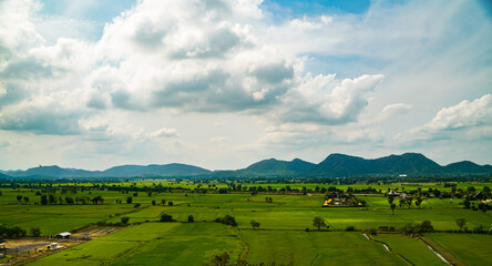 rice fields, sky and mountains  High angle view of Tiger Cave Temple  Kanchanaburi, Thailand