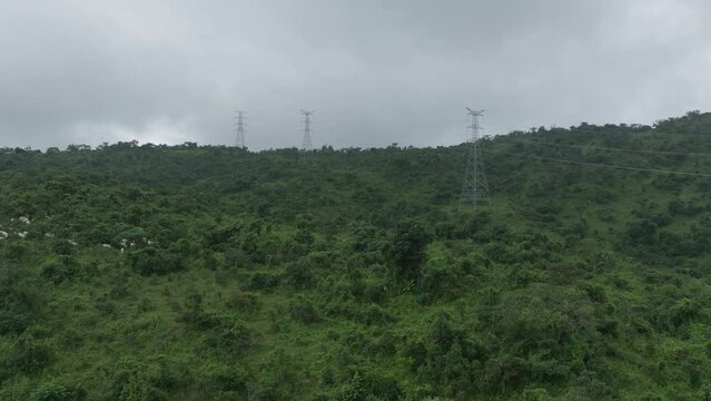 Aerial - Power lines across mountains, forward