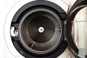 The empty washing machine has been left open.