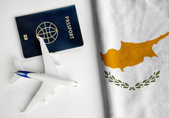 Flag of Cyprus with passport and toy airplane. Flight travel concept
