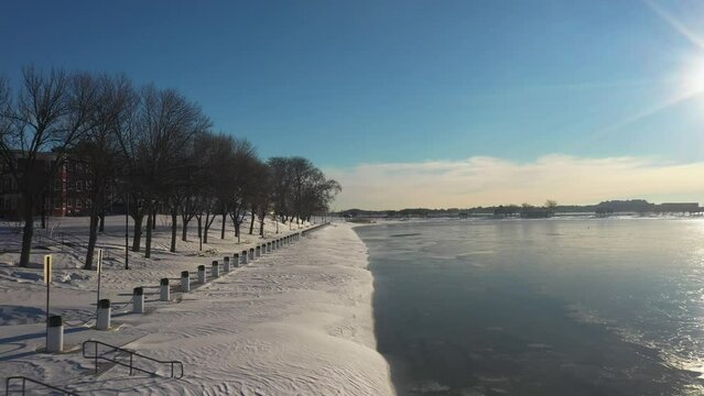 Frozen Winter Landscape Drone Footage With Sun Reflecting Off Water