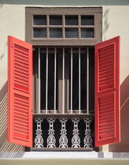 Prewar window with red shutters