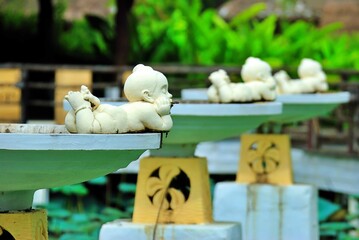 The stucco dolls beside the pool. 