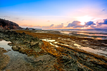 Sunset at Ekas Beach Lombok island, Indonesia. Beautiful stone structure and Unit 