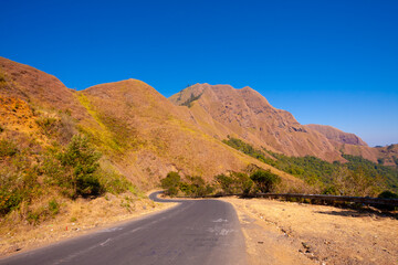 Travel photo with back ground mountain scenery and green forest.