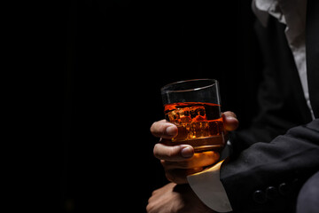 Closeup businessmen holding a glass of whiskey