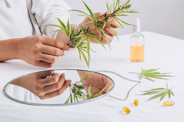Cannabis in hands. Pharmaceutical medicine pills, capsules on a white table. Concept Melatonin...