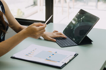 Businessman and team analyzing financial statement Finance task. with smart phone and laptop and tablet. Wealth management concept