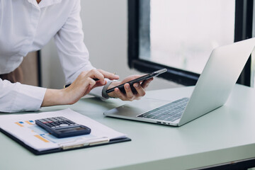 Businessman and team analyzing financial statement Finance task. with smart phone and laptop and tablet. Wealth management concept