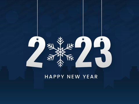 2023 Number Hang With Snowflake Against Blue Silhouette Buildings Background.
