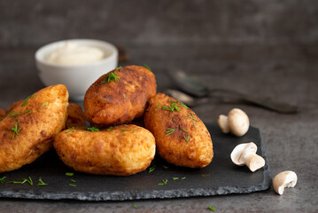 Fried patties with potatoes, mushrooms and green onions, homemade food