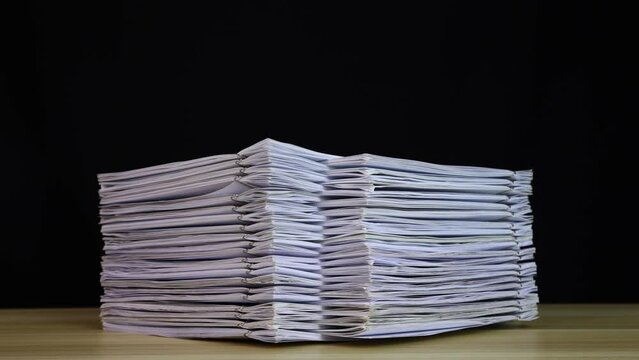 Rising stack of paper documents with clip on wooden table. Corporate business financial data management concept. Organize Documents &ndash; 4K Stop Motion, Stack Files Overload