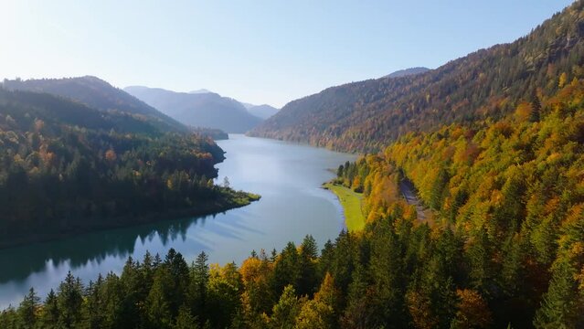 Aerial view across Sylvenstein Stausee lake over Isar idyllic alpine woodland valley