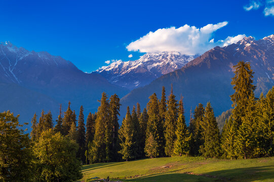 Landscape with mountains and clouds. Sunset over the mountains. Beautiful, serene camping site view of Himalayan snowscapes mountains, Kasol, Parvati valley, Himachal Pradesh, northern India.	
