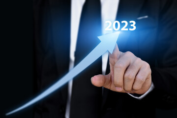 2023 year business growth concept. Businessman pointing arrow graph corporate future growing plan.