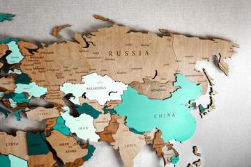 Continent Eurasia on the political map. Wooden world map on the wall, Russia, Kazakhstan, China, Mongolia, Iran