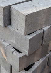 Large stack of gray concrete building blocks.