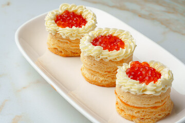 Naklejka na ściany i meble Red caviar in tartlets on white plate