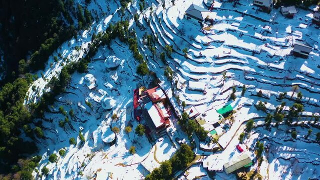 Mussoorie,Uttarakhand India- January 15 2022- Aerial winter landscape of trees and fields covered in snowfall . Snowfall in Mussoorie, Uttarakhand India. Aerial view of beautiful snow-covered