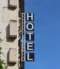 Hotel sign in Paris, France, with a blue sky background.