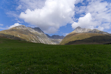 Mountain panorama with peak at Swiss mountain pass Oberalppass on a sunny late summer morning. Photo taken September 5th, 2022, Oberalp Pass, Switzerland.
