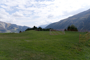 Beautiful scenic landscape with football field at Alp Milez, Canton Graub&uuml;nden, in the Swiss alps at region Oberalppass on a late summer day. Photo taken September 5th, 2022, Milez Dieni, Switzerland.