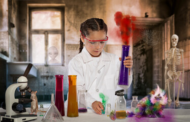Girl scientist and her mice in creepy lab experimenting with flasks potions and magic - 548144070