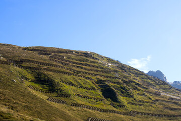 Mountain panorama at Swiss mountain pass Oberalppass witch avalanche protection on a sunny late summer morning. Photo taken September 5th, 2022, Oberalp Pass, Switzerland.