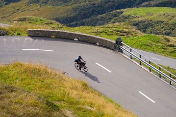 Aerial view of mountain pass road and tour cyclist at Swiss mountain pass Oberalppass on a late summer day. Photo taken September 5th, 2022, Oberalp Pass, Switzerland.