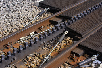 Close-up of railway track with cog wheels of narrow gauge railway at Swiss mountain pass Oberalppass on a blue cloudy late summer day. Photo taken September 5th, 2022, Oberalp Pass, Switzerland.