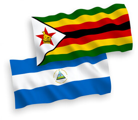 National vector fabric wave flags of Nicaragua and Zimbabwe isolated on white background. 1 to 2 proportion.