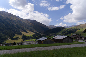 Fototapeta na wymiar Scenic view over mountain village Rueras, Canton Graubünden, on a blue cloudy late summer day. Photo taken September 5th, 2022, Rueras, Switzerland.