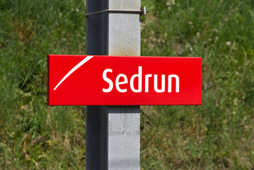 Close-up of red sign at railway station Sedrun of Matterhorn Gotthard Railway MGB, Canton...