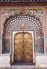 Classic ancient door background. Floral patterns and carvings on the entrance metal doors of the ancient City Palace in Jaipur, India.