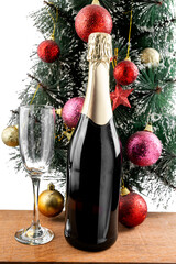 The champagne bottle and champagne glass with the Christmas tree