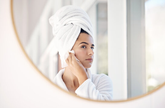 Mirror, skincare woman in bathroom for cleaning, facial and skin product or cotton in her home with mockup. Face, beauty and girl with hydration cosmetic treatment after shower, hygiene and grooming