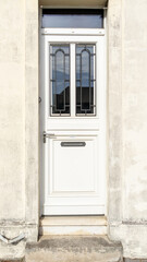 Fototapeta na wymiar door white wooden ancient home access restored of city house street facade