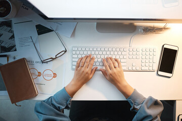 Computer, keyboard and typing with top view of woman and mockup on screen for research, planning and growth analytics. Technology, innovation and future with hands of employee at desk for management