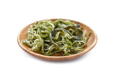 heap of fresh Korean salted seaweed salad stem side dish or Miyeok Julgi Bokkeum in wood bowl isolated on white background. Laminaria or Kelp Seaweed stem                              