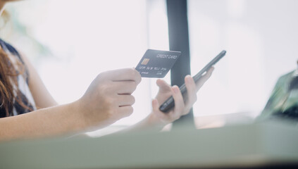 Businessman hand using laptop compter with holding cradit card payments online shopping or business.