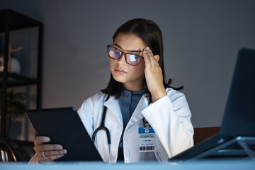 Woman, healthcare doctor and stress or headache on tablet for research in medical hospital. Young...