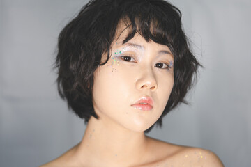 Portrait of young adult asian woman with makeup cosmetics decoration y2k make up fashion style